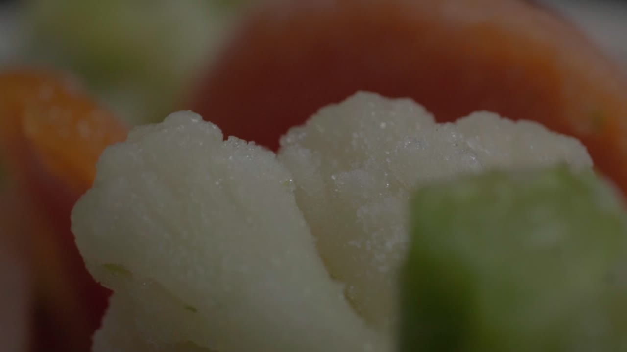 Detailed close-up shot of vibrant fresh salad ingredients including greens, vegetables, and a hint of orange, beautifully captured with soft lighting and rich, natural textures