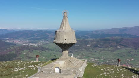 Aerial-drone-view-of-a-large-monument-statue-of-the-Virgin-of-Orduña-on-the-top-of-Mount-Txarlazo-in-the-Basque-Country