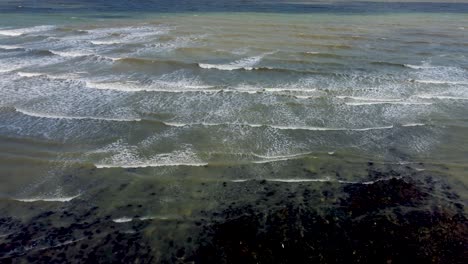 looking out to english channel shallow waves breaking over rocks