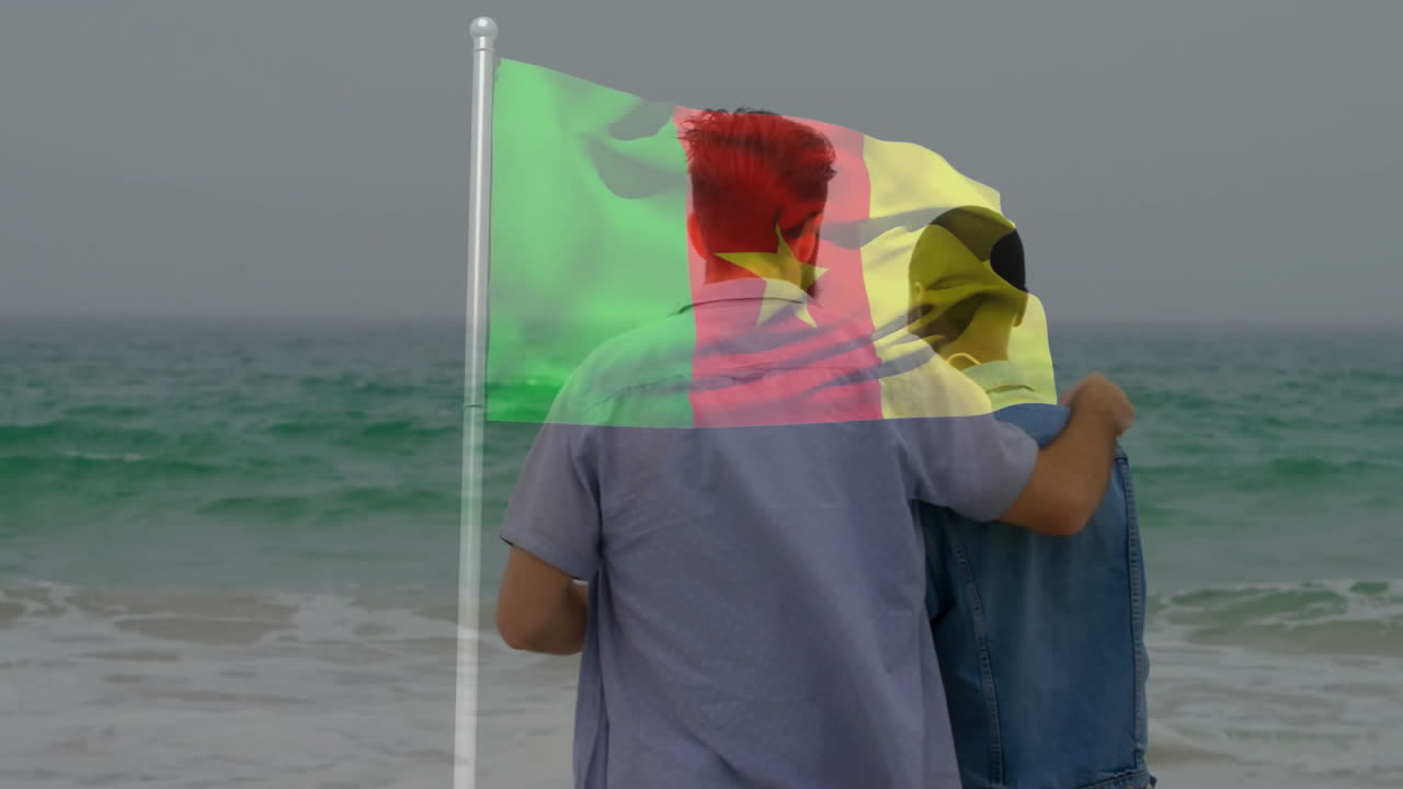Embracing on beach with Cameroon flag overlay, two people sharing moment