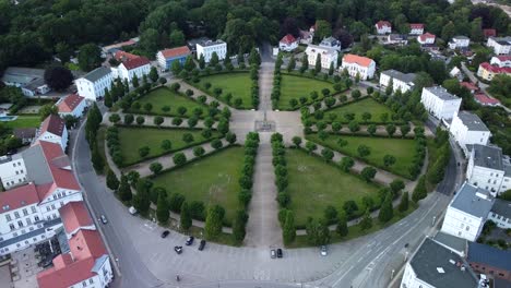 drone shot, showing the historical classic circus square of putbus town with white houses, located on the rügen island in germany