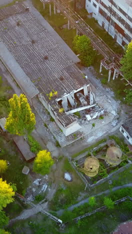 abandoned warehouses and factories. top view of the abandoned factory with broken windows and walls vertical video