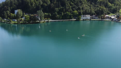 stand up paddle boarding on lake bled in slovenia - aerial shot