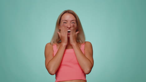 Stylish-woman-in-crop-top-shouting,-raising-fists-in-gesture-I-did-it,-celebrating-success,-winning