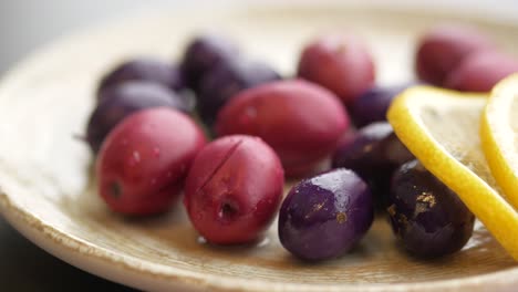 plate of red and purple olives with lemon slices