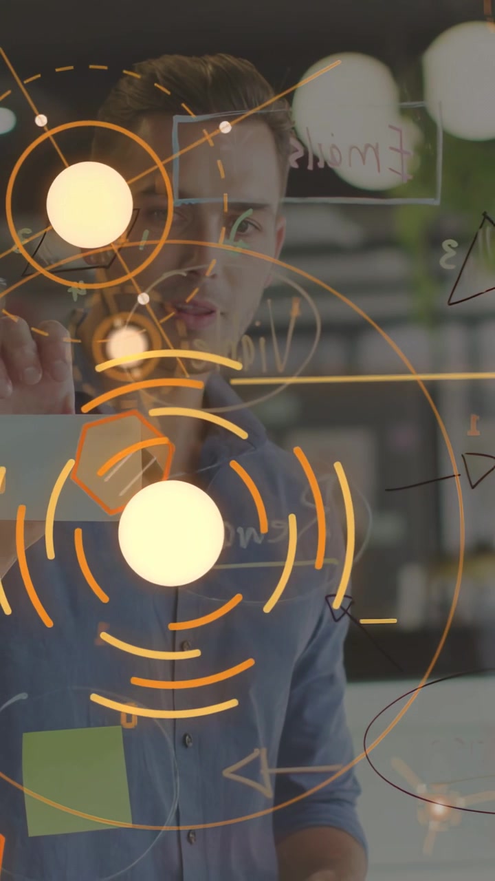 Vertical video: Man at glass board, colleague marking, writing while orange HUD aligning for design