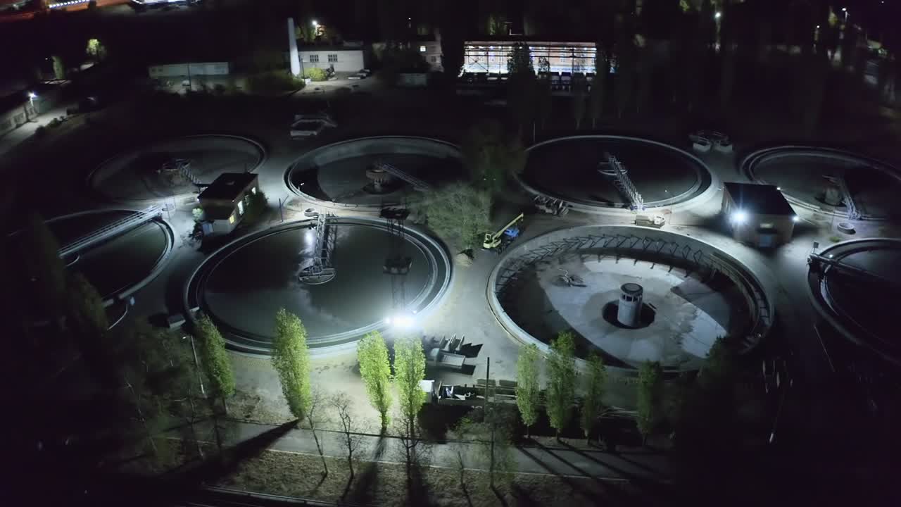 Aerial view at night wastewater treatment plant, filtration of dirty or sewage water