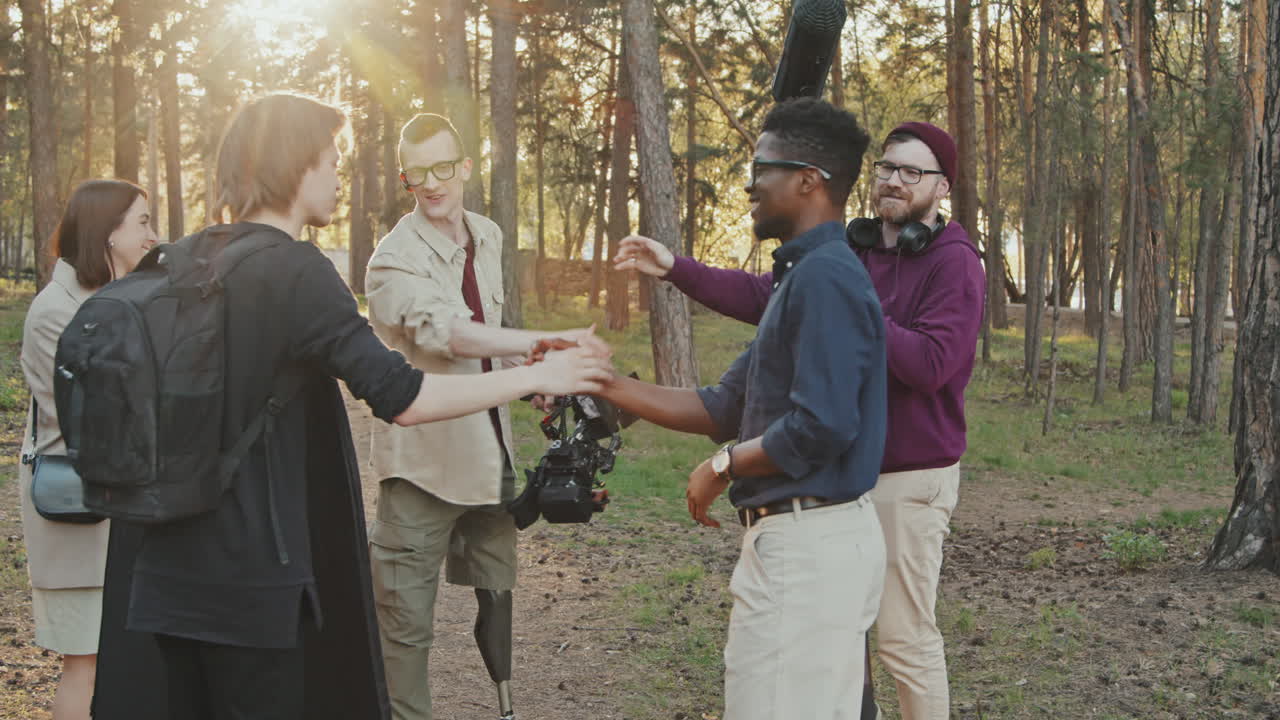 Filming Crew Giving High-Fives After Shooting Outdoors