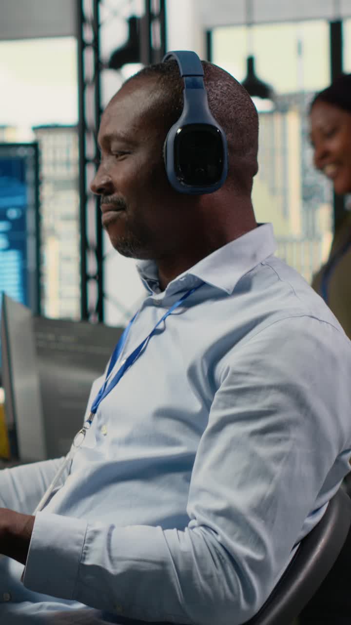 Vertical video Technician listening music in office, using AI specialized hardware