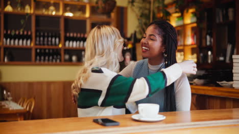 two friends enjoying coffee at a cafe