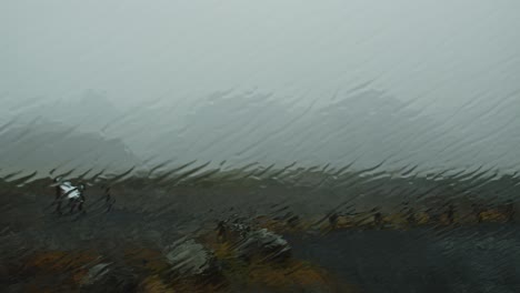 Wide-view-of-Icelandic-landscape-through-a-car-window-in-a-heavy-storm