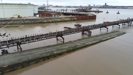 Drone-view-Tranmere-oil-terminal-Birkenhead-coastal-petrochemical-harbour-distribution-dolly-left-tilt-up