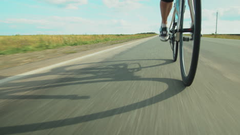 Female-Triathlete-Biking-on-Road