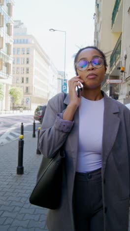 businesswoman talking on phone in city