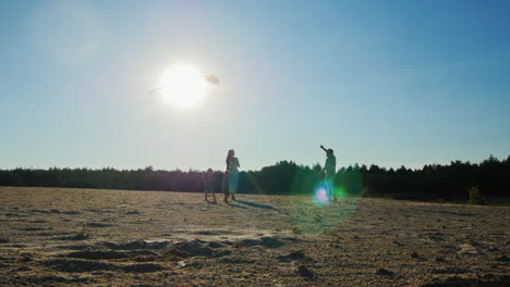 Young-Family-Of-Four-People-Relaxing-Together---Is-Launching-A-Kite