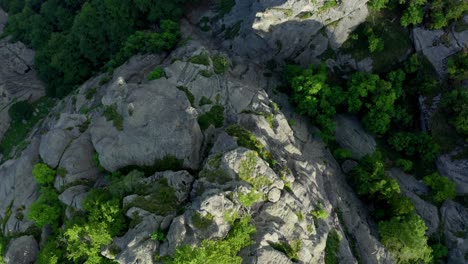 aerial top down shot of rocky rhodope mountains during sunny day in bulgaria, europe