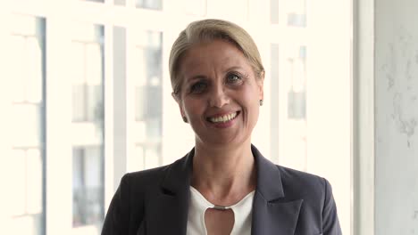 head shot portrait successful middle-aged businesswoman pose in office