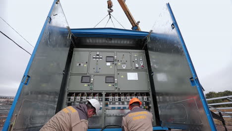 installing electrical panel at solar farm