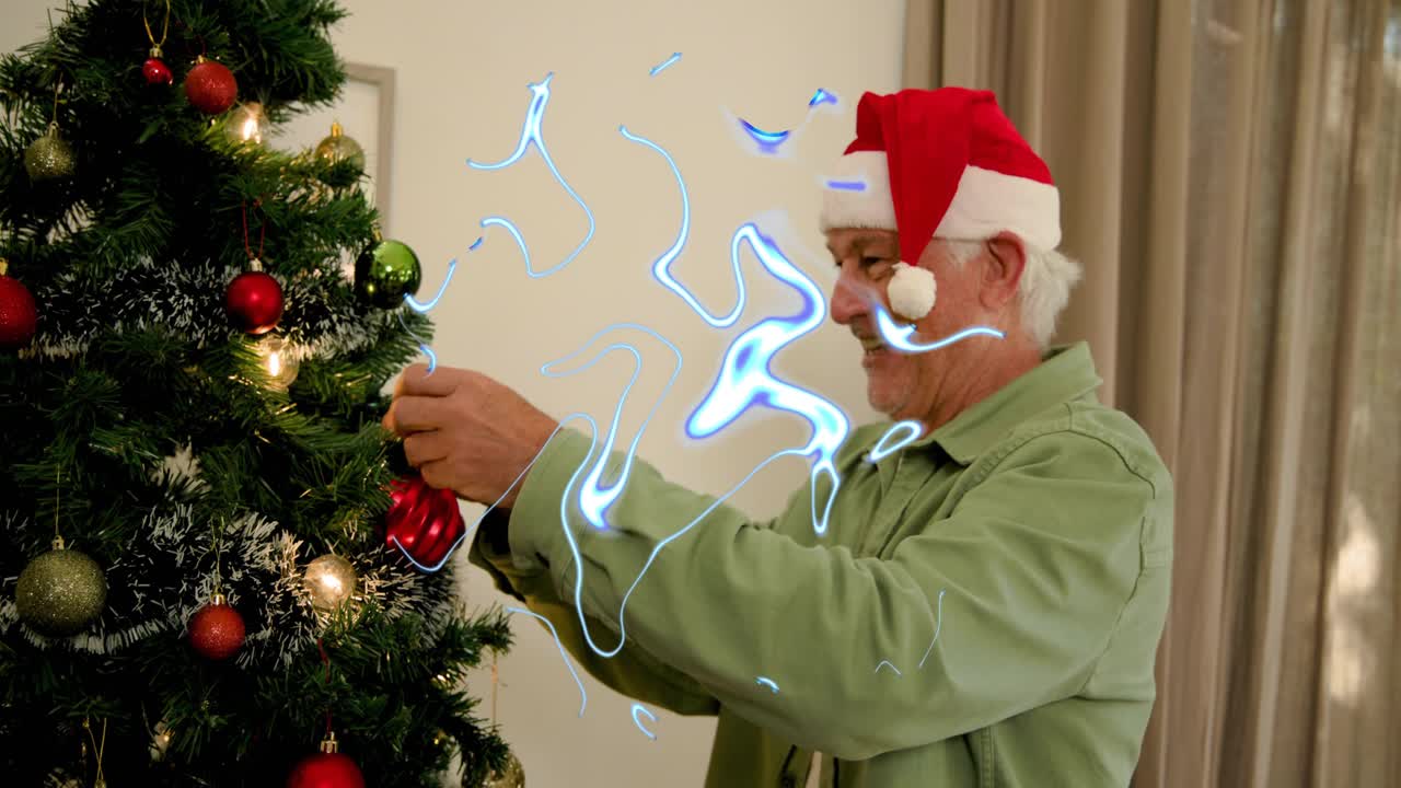 Senior man hanging red bauble on Xmas tree, securing ornaments for holiday, blue light drifting