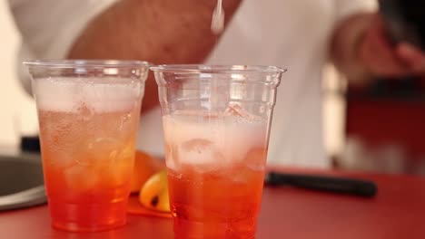 preparing aperol spritz cocktails