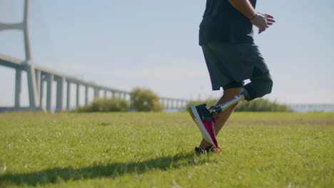 Closeup-shot-of-male-athlete-with-artificial-leg-jogging-in-park