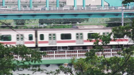 JR-Train-Passing-By-On-The-Bridge-In-Tamagawa-At-Daytime-In-Tokyo,-Japan