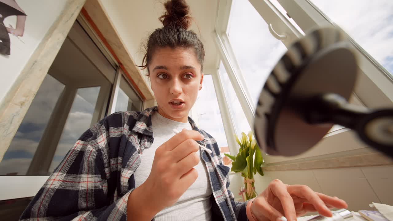 Young Woman Applying Eyeshadow with Cotton Swab