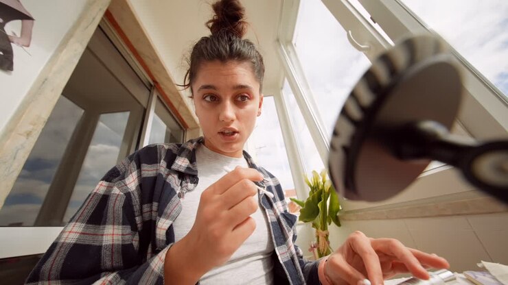 Young Woman Applying Eyeshadow with Cotton Swab
