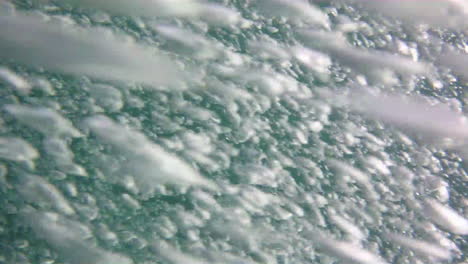 a cascade of bubbles from a scuba diver envelopes camera's point-of-view.