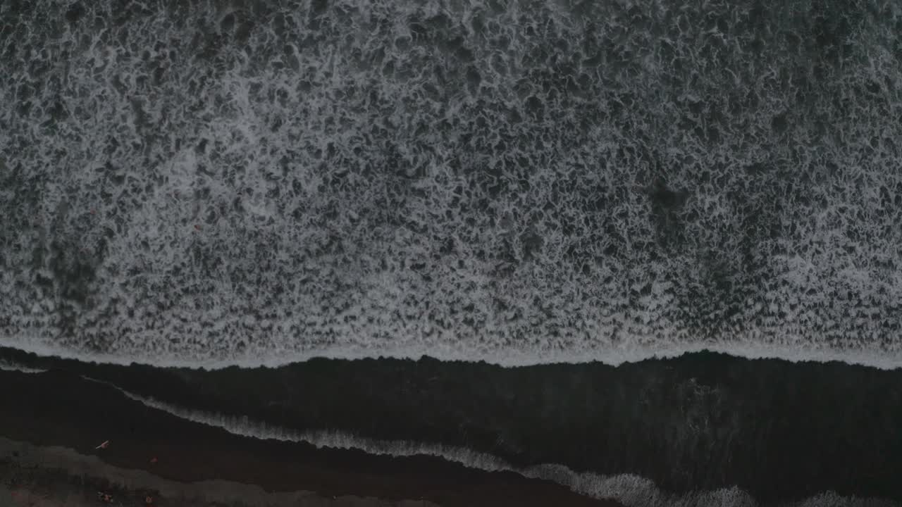 Aerial drone birds view shot of the ocean revealing the beach in Costa Rica 4k