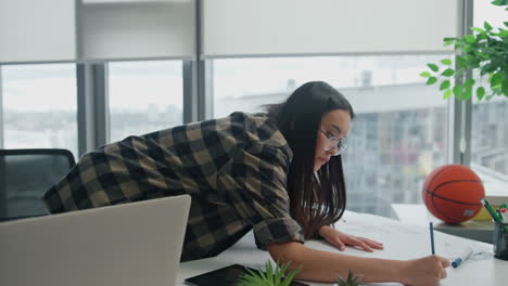 Inspired-engineer-drawing-blueprints-at-office-closeup.-Woman-creating-project