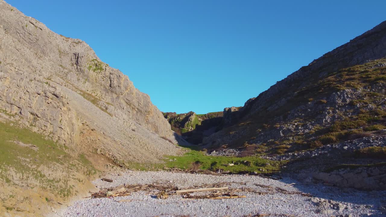 Ascending Aerial of Steep Valley with Crumbling Rocks and Sheer Cliffs. Travel Nature Drone Clip. Beautiful Welsh Gower Peninsula Coast