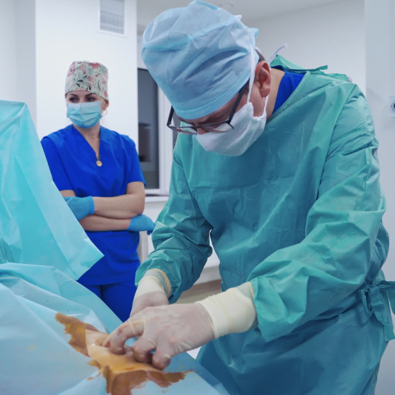 Doctors treating patient. Professional medical workers performing an operation to a patient in the hospital.