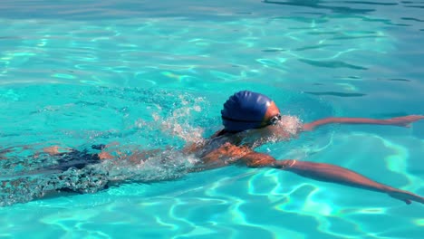 fit swimmer doing the breast stroke in the swimming pool