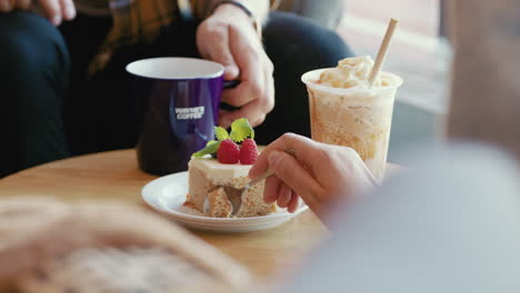 romantic young couple girl boy having a coffee break hand slices spoon of sponge chocolate cake with raspberries sugar filled layers hot chocolate delicious tasty snack food cupcake brownie cheesecake