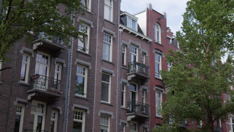exterior view of apartment buildings in amsterdam, netherlands. - pov from street