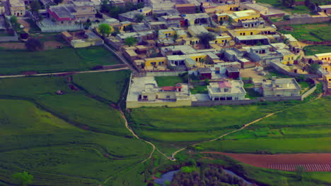 Village-in-the-farms,-Aerial-view,-Narrow-streets-crafted-in-the-farms