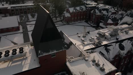 Snowy-Rooftop-Of-Bishop's-University-With-Sunbeam-During-Winter-In-Lennoxville,-Sherbrooke,-Quebec,-Canada