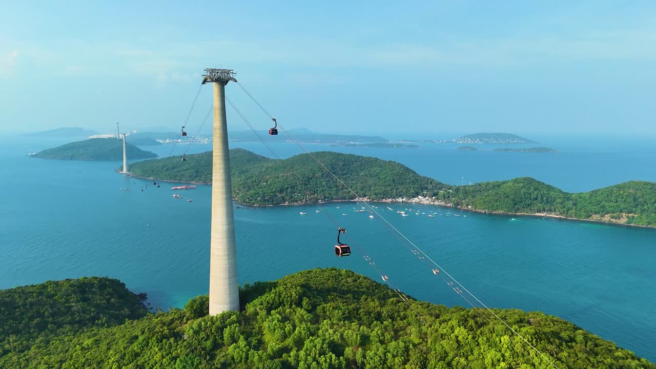 Aerial: longest three-rope cable car in the world during the day in Sunset Town, Phu Quoc Island, Vietnam, parallax drone shot