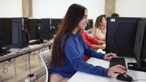 young students using computer inside school classroom