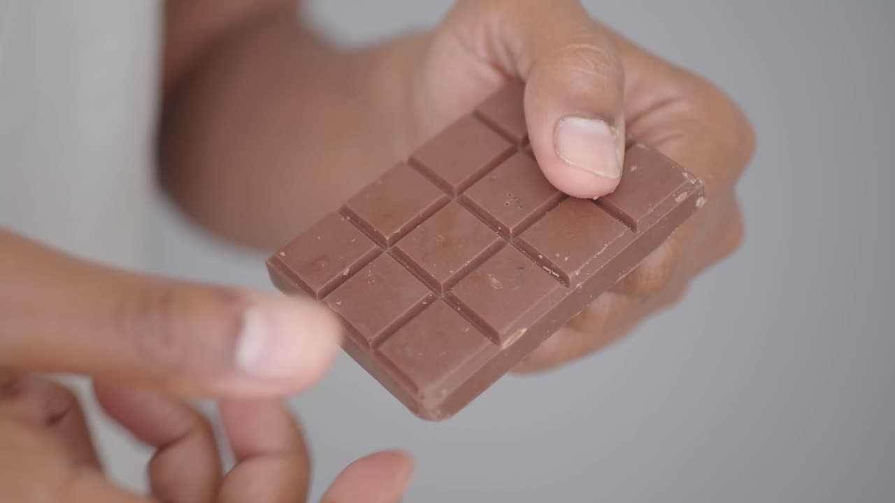 Chocolate bar being broken in half