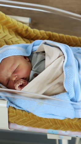 Concept of newborn baby lying. Parenthood adorable cute boy. Vertical video
