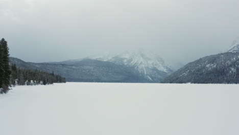 Aerial-over-frozen-Redfish-Lake-in-winter-Sawtooth-Mountains