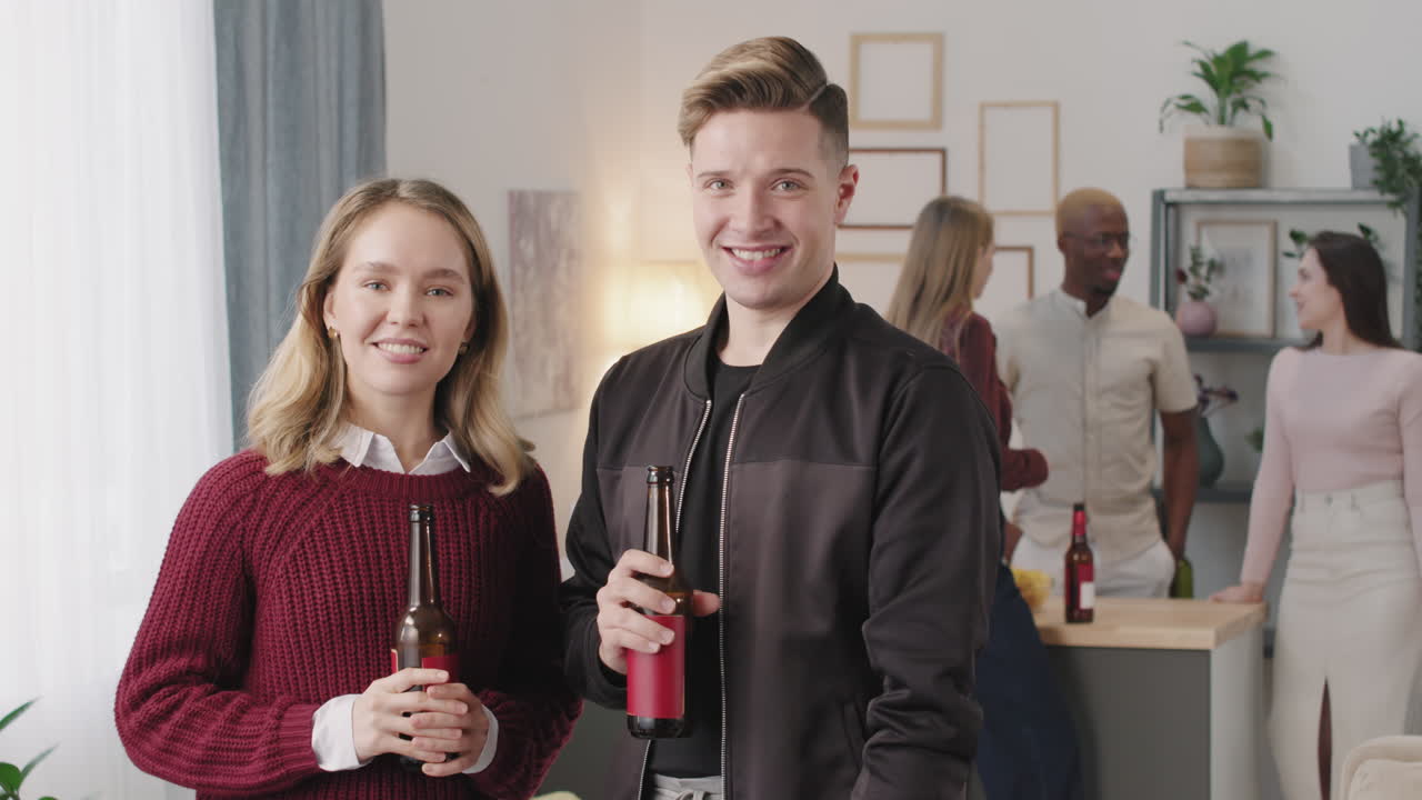 Happy Young Man and Woman at House Party