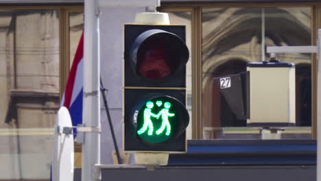 red lgbt traffic light turns to green with heart in vienna, austria