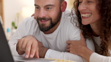 Couple,-smile-and-relax-in-bedroom-with-laptop