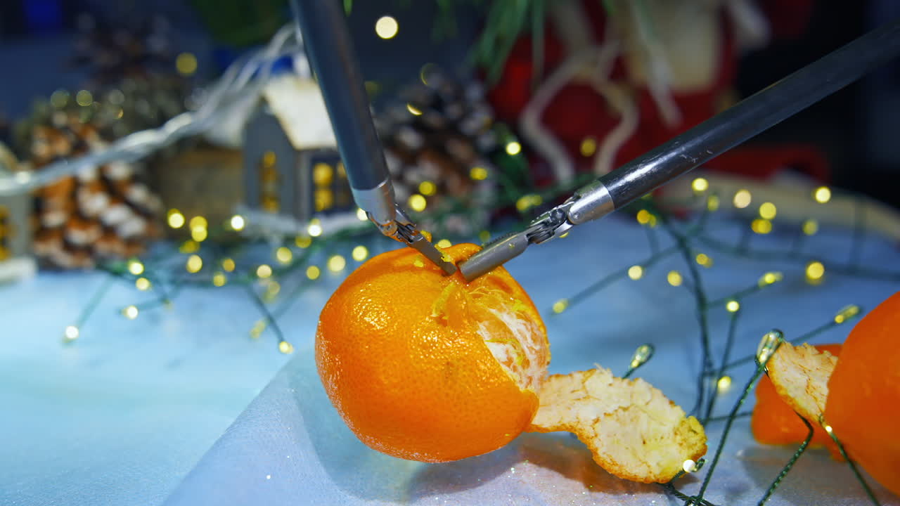 Human like robot peels tangerine while preparing to the Christmas. Cropped view. Computers concept