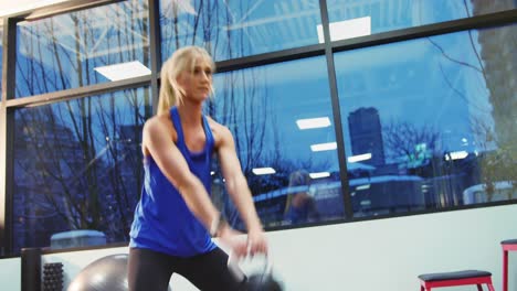 fit woman exercising with kettlebell