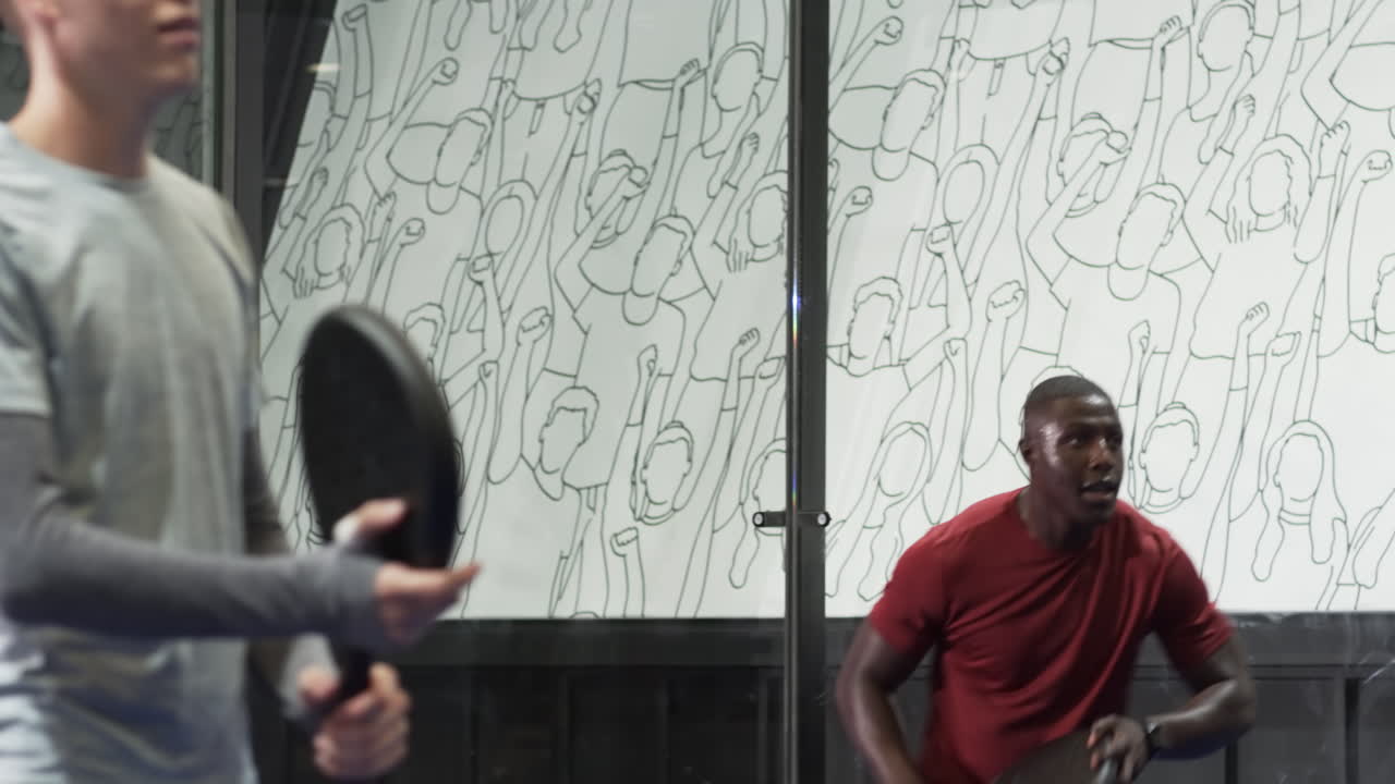 Man playing padel tennis on indoor court, holding racket and preparing for shot