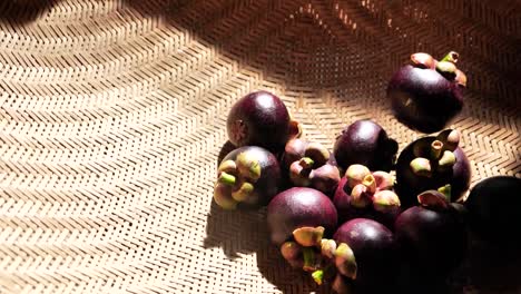 Mangosteen-Fruit-Roll-in-to-Basket,-Close-Up